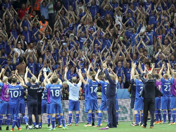 Iceland players celebrate with their supporters after defeating England in Euro 2016 Iceland players celebrate with their supporters after defeating England in Euro 2016