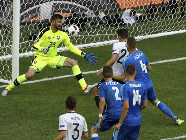 Germany's Mario Gomez, background right, scores his side's second goal besides Slovakia goalkeeper Matus Kozacik, left, during the Euro 2016 round of 16 soccer match between Germany and Slovakia, at the Pierre Mauroy stadium in Villeneuve d'Ascq, near Lille, France, on June 26, 2016. Germany's Mario Gomez, background right, scores his side's second goal besides Slovakia goalkeeper Matus Kozacik, left, during the Euro 2016 round of 16 soccer match between Germany and Slovakia, at the Pierre Mauroy stadium in Villeneuve d'Ascq, near Lille, France, on June 26, 2016.