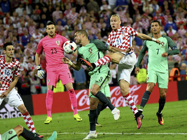Croatia's Domagoj Vida, center right, fights for the ball with Portugal's Pepe during the Euro 2016 round of 16 soccer match between Croatia and Portugal at the Bollaert stadium in Lens, France, on June 25, 2016. Croatia's Domagoj Vida, center right, fights for the ball with Portugal's Pepe during the Euro 2016 round of 16 soccer match between Croatia and Portugal at the Bollaert stadium in Lens, France, on June 25, 2016.