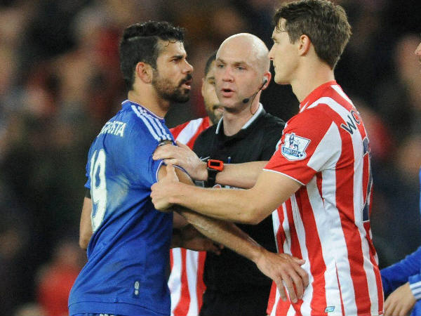 Referee Anthony Taylor (middle) speaks to Chelsea’s Diego Costa (left) and Stoke’s Philipp Wollscheid during a English Premier League match Referee Anthony Taylor (middle) speaks to Chelsea’s Diego Costa (left) and Stoke’s Philipp Wollscheid during a English Premier League match