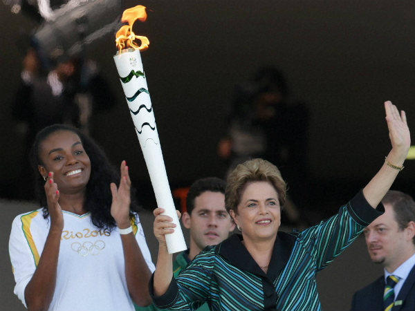 File photo: Brazil's President Dilma Rousseff holds the Olympic torch as Brazilian volleyball player Fabiana Claudino applauds after the torch was ignited at Planalto presidential palace in Brasilia, Brazil, Tuesday, May 3, 2016. File photo: Brazil's President Dilma Rousseff holds the Olympic torch as Brazilian volleyball player Fabiana Claudino applauds after the torch was ignited at Planalto presidential palace in Brasilia, Brazil, Tuesday, May 3, 2016.