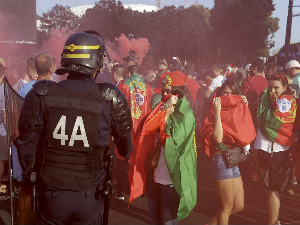 Portugal supporters cover their faces as other fans hold flares prior the Euro 2016 quarterfinal match between Poland and Portugal Portugal supporters cover their faces as other fans hold flares prior the Euro 2016 quarterfinal match between Poland and Portugal