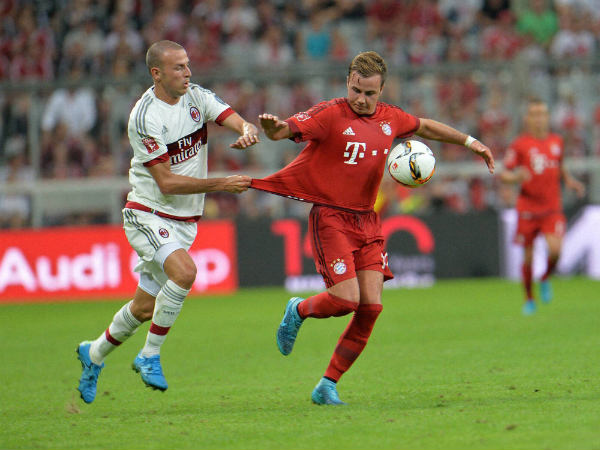 Mario Goetze (right) challenge for the ball with Milan's Luca Antonelli during the friendly match Mario Goetze (right) challenge for the ball with Milan's Luca Antonelli during the friendly match