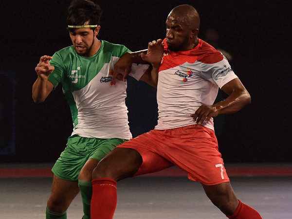 Kolkata5s (Red) player Pula in action against Bengaluru5s (Green) during their match of the Premier Futsal Football League Kolkata5s (Red) player Pula in action against Bengaluru5s (Green) during their match of the Premier Futsal Football League