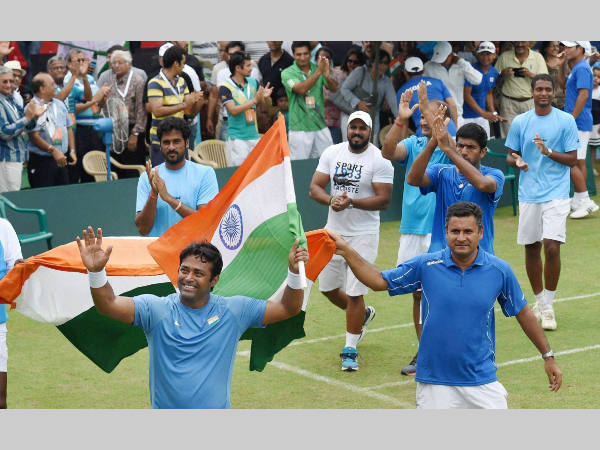 Paes (left), with the tri-colour, waves to the crowd after winning the doubles match with Bopanna in Davis Cup. Also seen are other members of the Indian team Paes (left), with the tri-colour, waves to the crowd after winning the doubles match with Bopanna in Davis Cup. Also seen are other members of the Indian team
