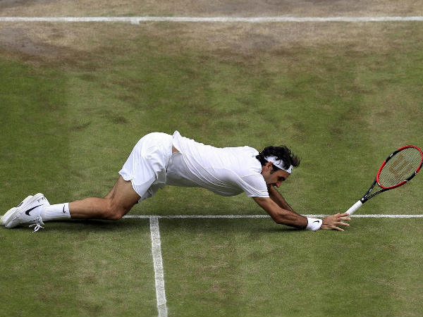 Federer falls during his match against Raonic Federer falls during his match against Raonic