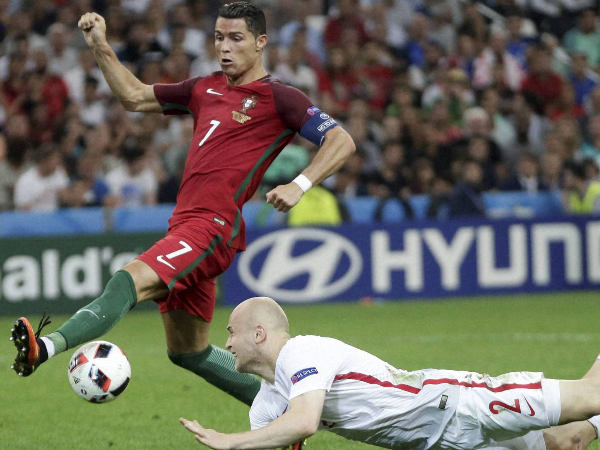 Cristiano Ronaldo, left, tries to control the ball near Poland's Michal Pazdan during the Euro 2016 quarterfinal soccer match between Poland and Portugal Cristiano Ronaldo, left, tries to control the ball near Poland's Michal Pazdan during the Euro 2016 quarterfinal soccer match between Poland and Portugal