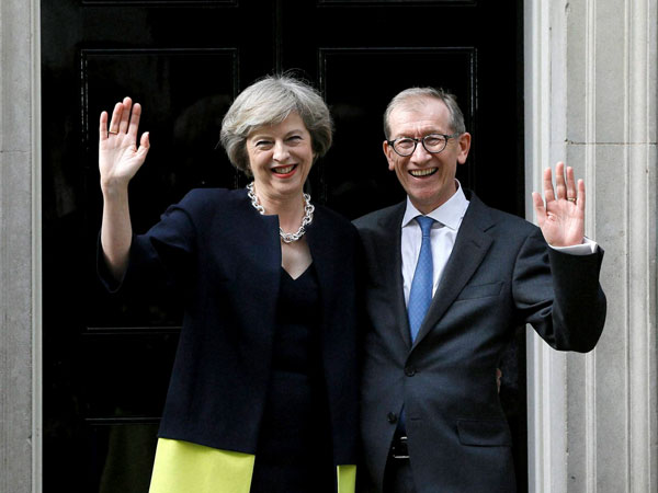 New British Prime Minister Theresa May and her husband Philip May wave from the steps of 10 Downing Street in London. New British Prime Minister Theresa May and her husband Philip May wave from the steps of 10 Downing Street in London.