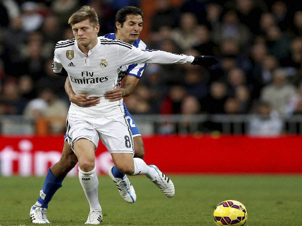 Toni Kroos (left) is grabbed by Celso Borges while they duel for the ball during a match between Real Madrid and Deportivo La Coruna Toni Kroos (left) is grabbed by Celso Borges while they duel for the ball during a match between Real Madrid and Deportivo La Coruna