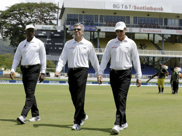 Umpires Nigel Llong, center, Gregory Brathwaite, left, and Rod Tucker inspect inspect the field as a wet ground delays the start of day two of the fourth cricket Test match between India and West Indies at Queen's Park Oval in Port-of-Spain. Umpires Nigel Llong, center, Gregory Brathwaite, left, and Rod Tucker inspect inspect the field as a wet ground delays the start of day two of the fourth cricket Test match between India and West Indies at Queen's Park Oval in Port-of-Spain.