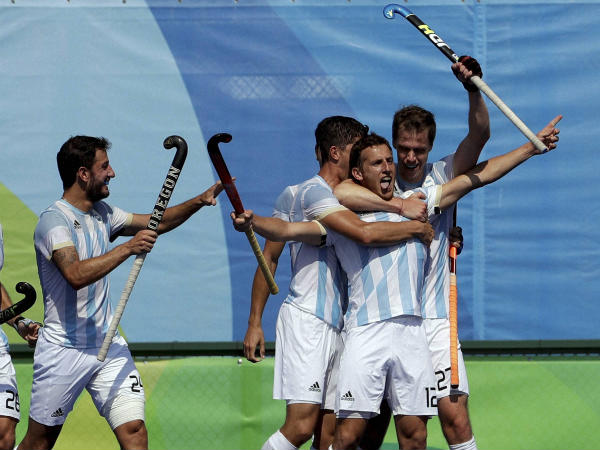 Argentina players celebrate after scoring against Germany in the men's field hockey semi-final match Argentina players celebrate after scoring against Germany in the men's field hockey semi-final match