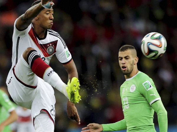 Jerome Boateng (left) clears a ball while defending against Algeria Jerome Boateng (left) clears a ball while defending against Algeria