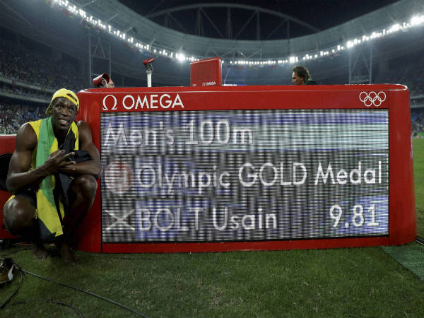 Usain Bolt poses beside the timing panel after winning the gold medal in the men's 100-meter final at the Rio Olympics 2016 Usain Bolt poses beside the timing panel after winning the gold medal in the men's 100-meter final at the Rio Olympics 2016