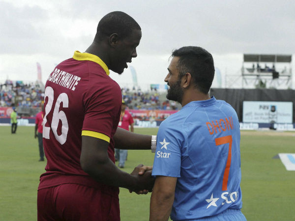 West Indies' Carlos Brathwaite (26) shakes hands with India's MS Dhoni (7) after the second Twenty20 international cricket match was called off due to rain, Sunday, Aug. 28, 2016, in Lauderhill West Indies' Carlos Brathwaite (26) shakes hands with India's MS Dhoni (7) after the second Twenty20 international cricket match was called off due to rain, Sunday, Aug. 28, 2016, in Lauderhill