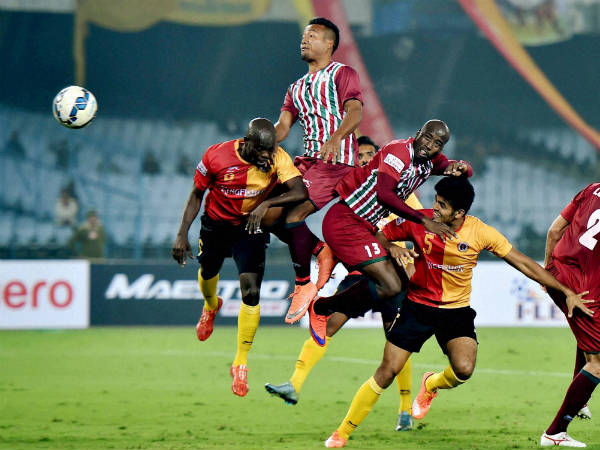 Mohun Bagan (green and maroon) and East Bengal (red and gold) players in action Mohun Bagan (green and maroon) and East Bengal (red and gold) players in action