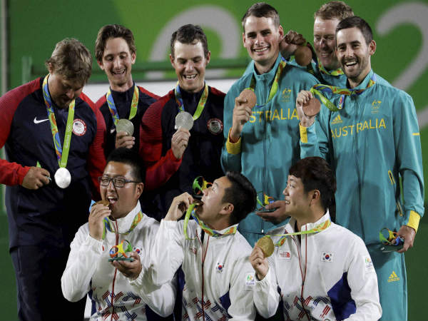 Gold medalists from South Korea (bottom) celebrate their triumph in men's archery Gold medalists from South Korea (bottom) celebrate their triumph in men's archery