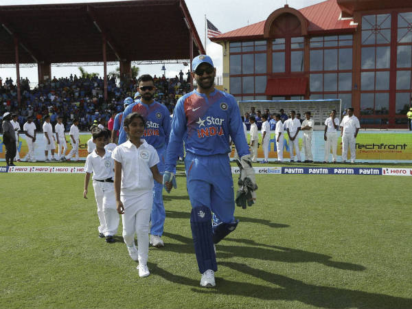 MS Dhoni (front, right) leads the Indian team onto the field in 1st T20I, to set a record MS Dhoni (front, right) leads the Indian team onto the field in 1st T20I, to set a record