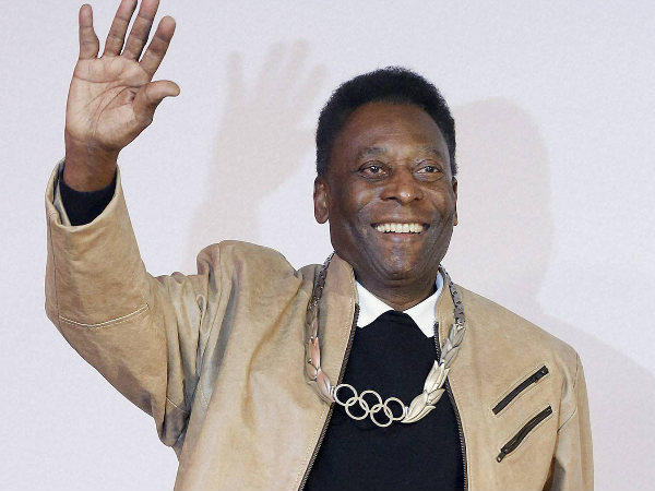 Pele waves during a ceremony at which he was awarded the Olympic Order at the Pele Museum Pele waves during a ceremony at which he was awarded the Olympic Order at the Pele Museum