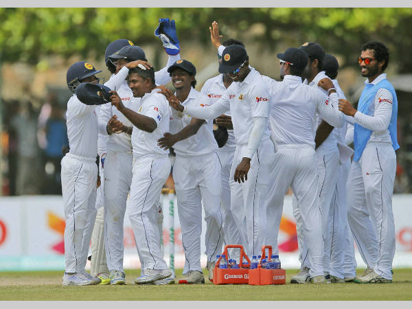 Rangana Herath (2nd left, with cap in left hand) is congratulated by team-mates after taking a hat-trick against Australia in 2nd Test in Galle on August 5 Rangana Herath (2nd left, with cap in left hand) is congratulated by team-mates after taking a hat-trick against Australia in 2nd Test in Galle on August 5