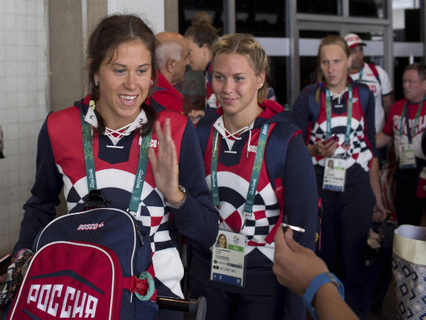 Members of the Russian Olympic delegation line up to board a bus after arriving at the Rio de Janeiro International Airport Members of the Russian Olympic delegation line up to board a bus after arriving at the Rio de Janeiro International Airport