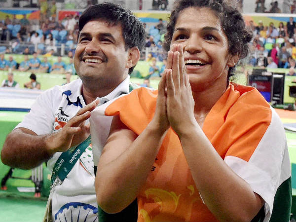 Sakshi Malik (right) with her coach Kuldeep Singh, celebrate after winning bronze Sakshi Malik (right) with her coach Kuldeep Singh, celebrate after winning bronze