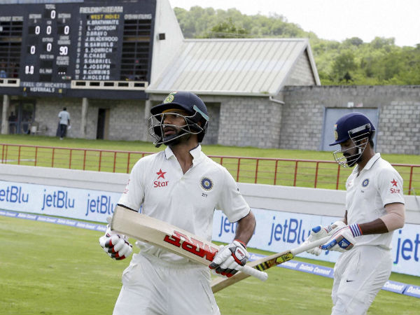 India's batsmen Shikhar Dhawan, left, and Lokesh Rahul walk to the pitch to start against West Indies on day one of their third cricket Test match. India's batsmen Shikhar Dhawan, left, and Lokesh Rahul walk to the pitch to start against West Indies on day one of their third cricket Test match.