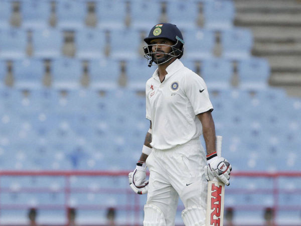 Shikhar Dhawan looks at the board as he leaves the field after he was caught by West Indies' wicketkeeper Shane Dorwich on day one of their third cricket Test match. Shikhar Dhawan looks at the board as he leaves the field after he was caught by West Indies' wicketkeeper Shane Dorwich on day one of their third cricket Test match.