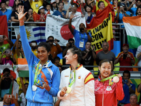 (L-R) Silver medalist V. Sindhu Pusarla of India, gold medalist Carolina Marin of Spain and bronze medalist Nozomi Okuhara of Japan celebrate during the medal ceremony after the Women's Singles Badminton competition on Day 14 of the Rio 2016 Olympic Games at Rio de Janeiro. (L-R) Silver medalist V. Sindhu Pusarla of India, gold medalist Carolina Marin of Spain and bronze medalist Nozomi Okuhara of Japan celebrate during the medal ceremony after the Women's Singles Badminton competition on Day 14 of the Rio 2016 Olympic Games at Rio de Janeiro.