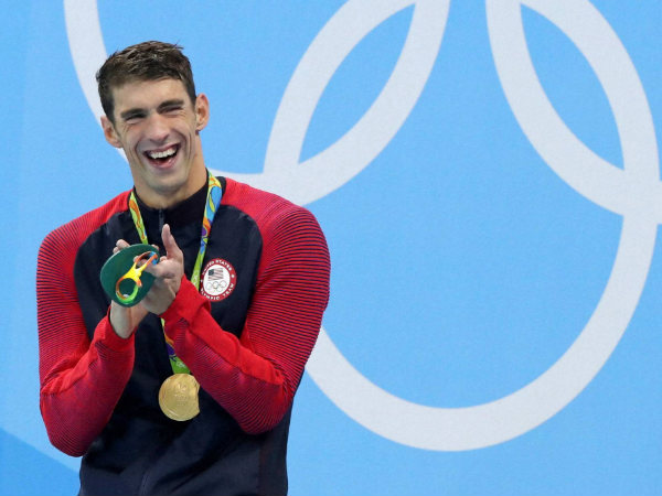Michael Phelps celebrates with his gold medal after the men's 200-meter butterfly Michael Phelps celebrates with his gold medal after the men's 200-meter butterfly