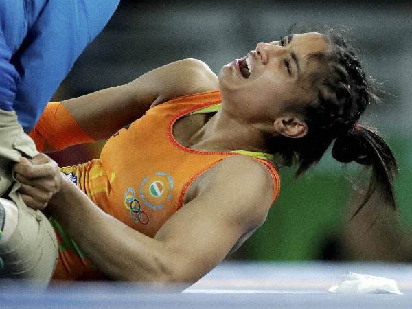 India's Vinesh Vinesh reacts as she is attended to by a doctor after getting injured in her match against China's Sun Yanan during the women's wrestling freestyle 48-kg competition at the 2016 Summer Olympics in Rio de Janeiro, Brazil, Wednesday. India's Vinesh Vinesh reacts as she is attended to by a doctor after getting injured in her match against China's Sun Yanan during the women's wrestling freestyle 48-kg competition at the 2016 Summer Olympics in Rio de Janeiro, Brazil, Wednesday.
