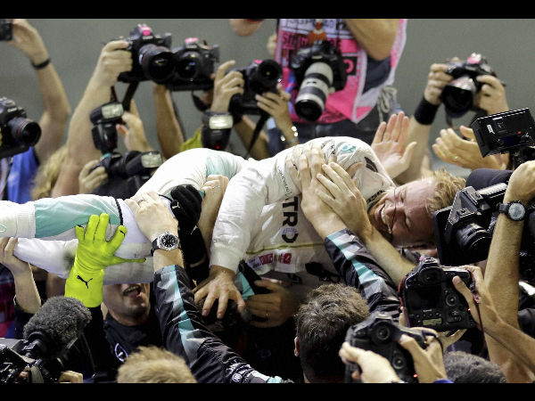 Mercedes driver Nico Rosberg of Germany is embraced by his team after winning the Singapore Formula One Grand Prix on the Marina Bay City Circuit Singapore, Sunday, Sept. 18, 2016. Mercedes driver Nico Rosberg of Germany is embraced by his team after winning the Singapore Formula One Grand Prix on the Marina Bay City Circuit Singapore, Sunday, Sept. 18, 2016.