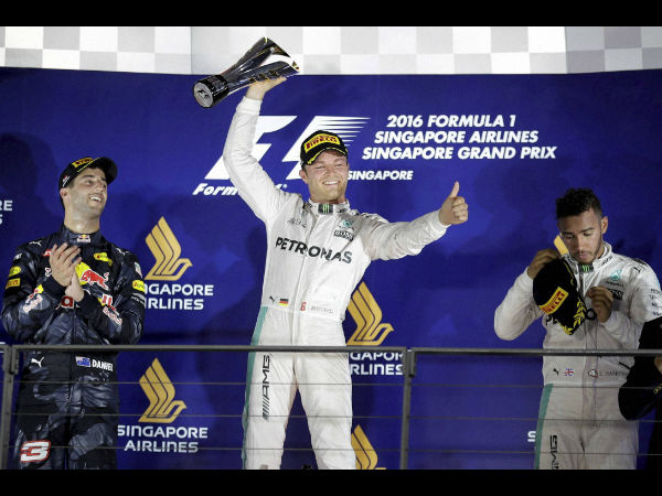 Mercedes driver Nico Rosberg of Germany celebrates after winning the Singapore Formula One Grand Prix on the Marina Bay City Circuit Singapore, Sunday, Sept. 18, 2016.Red Bull driver Daniel Ricciardo, left, of Australia finished second and Mercedes driver Lewis Hamilton, right, of Britain third. Mercedes driver Nico Rosberg of Germany celebrates after winning the Singapore Formula One Grand Prix on the Marina Bay City Circuit Singapore, Sunday, Sept. 18, 2016.Red Bull driver Daniel Ricciardo, left, of Australia finished second and Mercedes driver Lewis Hamilton, right, of Britain third.