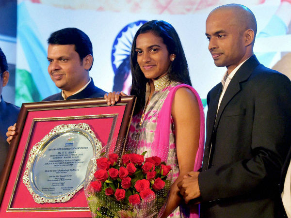 Maharashtra Chief Minister Devendra Fadnavis felicitates Olympic silver medallist shuttler P V Sindhu and her coach Gopichand in Mumbai. Maharashtra Chief Minister Devendra Fadnavis felicitates Olympic silver medallist shuttler P V Sindhu and her coach Gopichand in Mumbai.