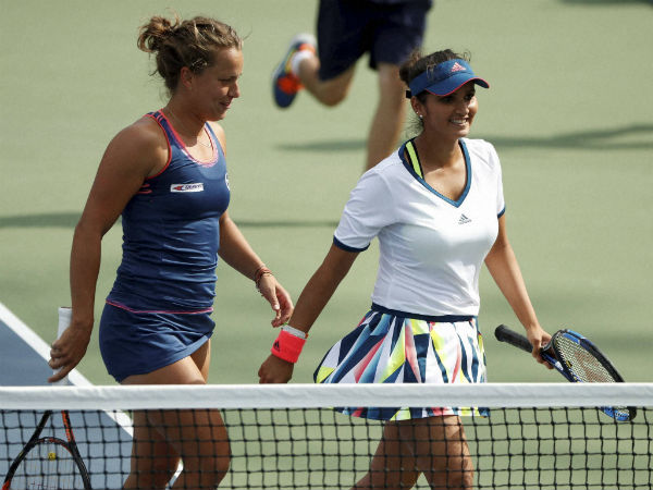 Sania Mirza, right, and doubles partner Barbora Strycova, of the Czech Republic, walk to their bench between games against Nicole Gibbs, of the United States, and Nao Hibino, of Japan, during the third round of the U.S. Open tennis tournament. Sania Mirza, right, and doubles partner Barbora Strycova, of the Czech Republic, walk to their bench between games against Nicole Gibbs, of the United States, and Nao Hibino, of Japan, during the third round of the U.S. Open tennis tournament.