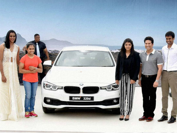 Dipa (2nd left) poses with her BMW car along with Sindhu (left), Sakshi Malik (3rd right), Sachin Tendulkar (2nd right) and Pullela Gopichand Dipa (2nd left) poses with her BMW car along with Sindhu (left), Sakshi Malik (3rd right), Sachin Tendulkar (2nd right) and Pullela Gopichand