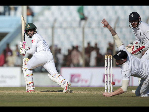 Bangladesh's test cricket team captain Mushfiqur Rahim, left, plays a shot, as England's Ben Stokes, center, fields during the second day of their first cricket test match in Chittagong. Bangladesh's test cricket team captain Mushfiqur Rahim, left, plays a shot, as England's Ben Stokes, center, fields during the second day of their first cricket test match in Chittagong.