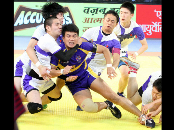 Japanese kabaddi team player try to catch Thailand's (blue) player during "Kabaddi World Cup 2016" match in Ahmedabad on Wednesday. Japanese kabaddi team player try to catch Thailand's (blue) player during "Kabaddi World Cup 2016" match in Ahmedabad on Wednesday.