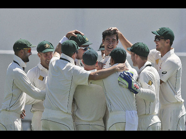 Australia's Mitchell Starc, center, celebrate with his team after taking the wicket of South Africa's Stephen Cook for a duck on the first day of play in their cricket test match against South Africa. Australia's Mitchell Starc, center, celebrate with his team after taking the wicket of South Africa's Stephen Cook for a duck on the first day of play in their cricket test match against South Africa.