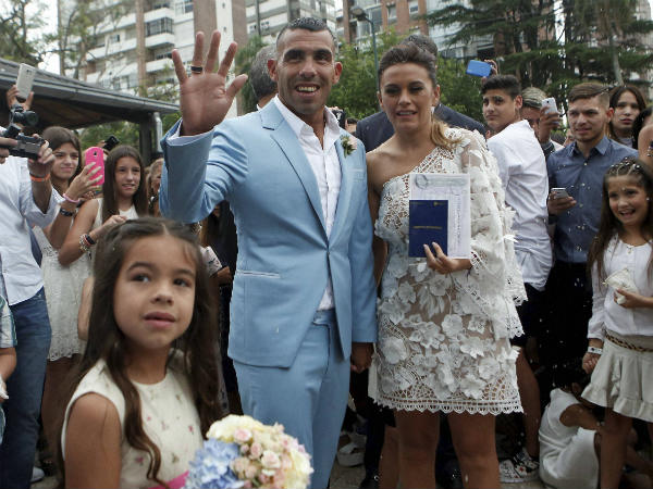 Carlos Tevez and his wife Vanesa Mansilla pose for photos after exiting the church where they married in in Buenos Aires, Argentina, Thursday, December 22 Carlos Tevez and his wife Vanesa Mansilla pose for photos after exiting the church where they married in in Buenos Aires, Argentina, Thursday, December 22