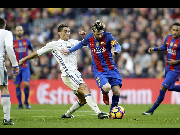 Barcelona's Lionel Messi, center right, escapes Real Madrid's Cristiano Ronaldo during the Spanish La Liga soccer match between FC Barcelona and Real Madrid at the Camp Nou in Barcelona, Spain Barcelona's Lionel Messi, center right, escapes Real Madrid's Cristiano Ronaldo during the Spanish La Liga soccer match between FC Barcelona and Real Madrid at the Camp Nou in Barcelona, Spain