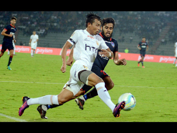 Players of Northeast United FC (in white jersey) and Delhi Dynamos FC (in blue jersey) vie for the ball during their ISL Match , at Indira Gandhi Athletics Stadium in Guwahati. Players of Northeast United FC (in white jersey) and Delhi Dynamos FC (in blue jersey) vie for the ball during their ISL Match , at Indira Gandhi Athletics Stadium in Guwahati.