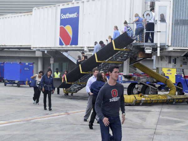 Panicked passengers running across tarmac