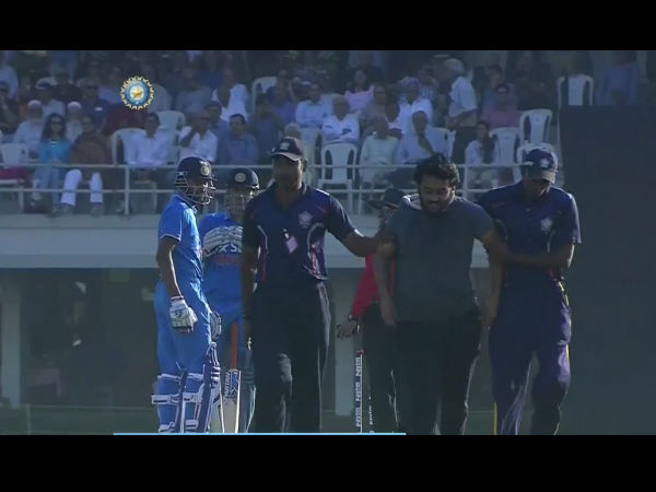 Fan taken away by security personnel