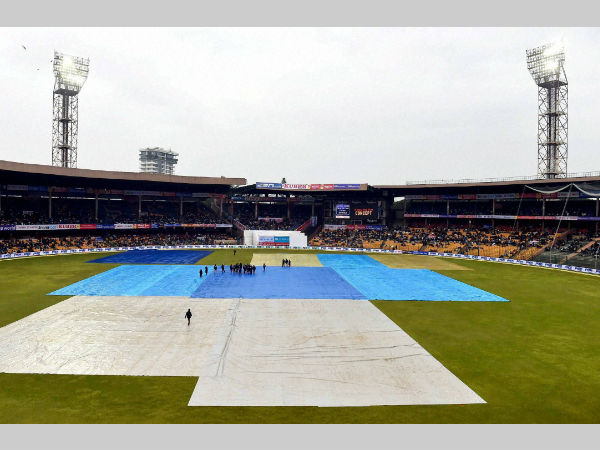 File photo: Bengaluru's M Chinnaswamy Stadium's most part of the ground is under covers after rain. With the latest drainage system, stoppage of play due to rain will be less. File photo: Bengaluru's M Chinnaswamy Stadium's most part of the ground is under covers after rain. With the latest drainage system, stoppage of play due to rain will be less.