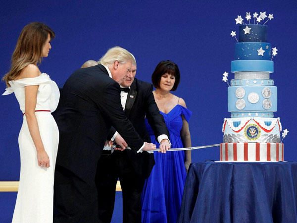 First lady Melania Trump watches as President Donald J. Trump, and Vice President Mike Pence cut a cake at The Salute To Our Armed Services Inaugural Ball in Washington. Karen Pence watches at right. First lady Melania Trump watches as President Donald J. Trump, and Vice President Mike Pence cut a cake at The Salute To Our Armed Services Inaugural Ball in Washington. Karen Pence watches at right.