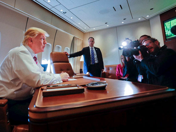 President Donald Trump sits at his desk on Air Force One upon his arrival at Andrews Air Force Base, Md., Thursday, Jan. 26, 2017. At the center is Chief of Staff Reince Priebus. President Donald Trump sits at his desk on Air Force One upon his arrival at Andrews Air Force Base, Md., Thursday, Jan. 26, 2017. At the center is Chief of Staff Reince Priebus.