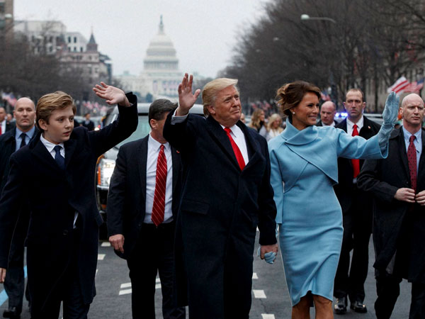 President Donald Trump and first lady Melania Trump walk along the Inauguration Day parade route after being sworn in as the 45th President of the United States. President Donald Trump and first lady Melania Trump walk along the Inauguration Day parade route after being sworn in as the 45th President of the United States.