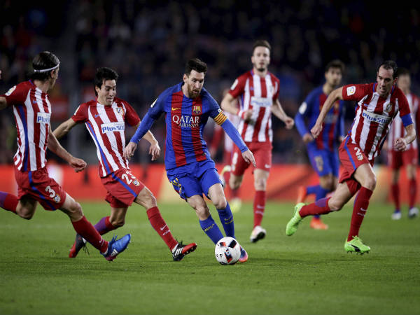 Lionel Messi (centre) in action against Atletico Madrid Lionel Messi (centre) in action against Atletico Madrid