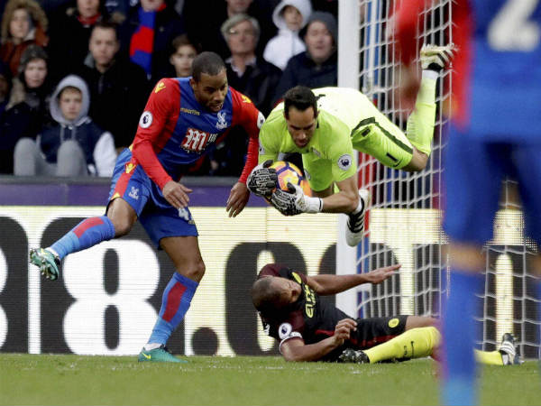 File photo: Manchester City's goalkeeper Claudio Bravo (top) lands after colliding with his teammate Vincent Kompany File photo: Manchester City's goalkeeper Claudio Bravo (top) lands after colliding with his teammate Vincent Kompany