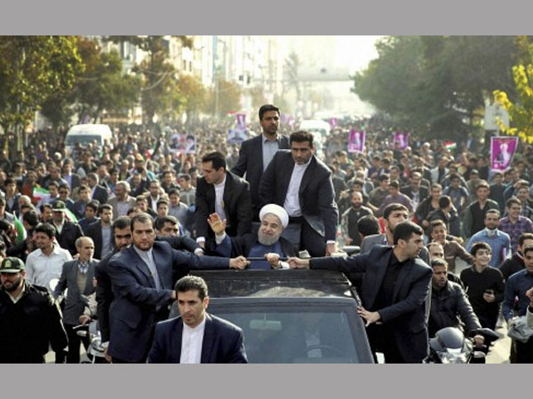 In this photo released by an official website of the office of the Iranian Presidency, Iranian President Hassan Rouhani, center, waves to his well-wishers from his car during a public welcoming ceremony for him upon his arrival. In this photo released by an official website of the office of the Iranian Presidency, Iranian President Hassan Rouhani, center, waves to his well-wishers from his car during a public welcoming ceremony for him upon his arrival.